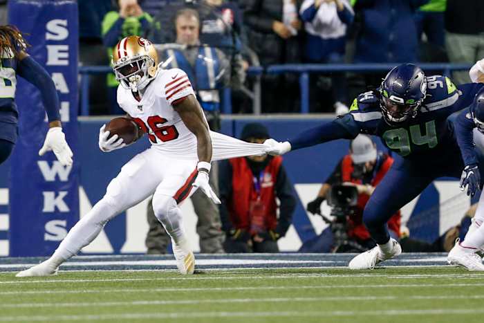Seattle Seahawks defensive end Ezekiel Ansah (94) tackles San Francisco 49ers running back Tevin Coleman (26) during the first quarter at CenturyLink Field.